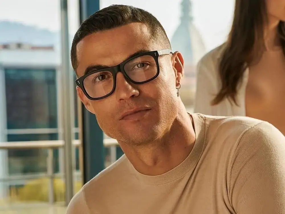 Ronaldo with short hair and glasses